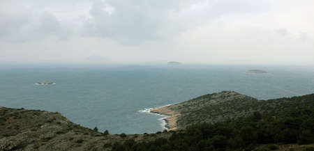 Cloudy weather on sea and islands in the distance の写真素材