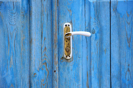 background of blue wooden door with close-up handle. High quality photoの写真素材