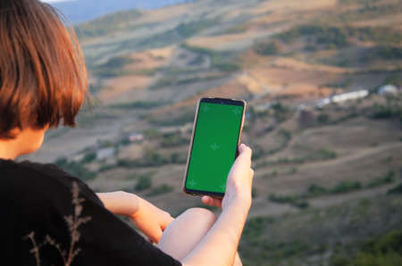 a man in nature in the hands of a phone with a screen for recording. High quality photoの写真素材