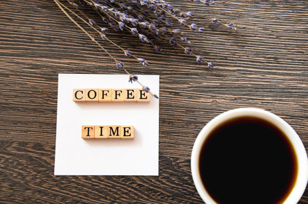 cup of coffee next to lavender flowers and inscription time coffee, view from top. High quality photoの写真素材
