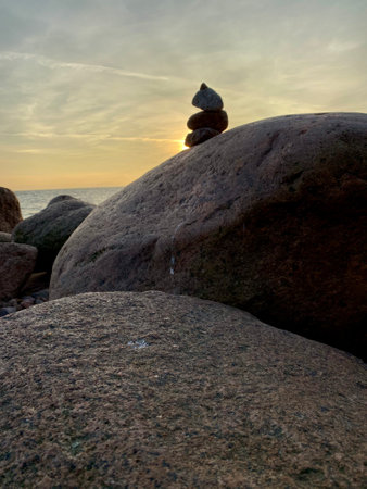 sunset on the rocky shore. stones lined with a slide in the setting sun. High quality photo