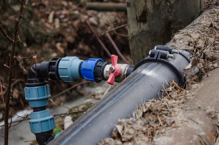 A tap is connected to the pipe to switch the water on the street. High quality photo