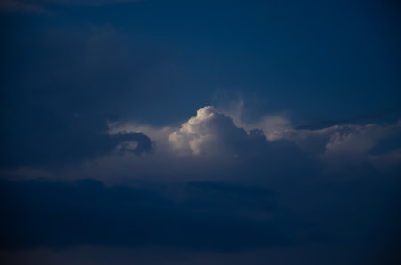 Dark sky with sunshine through the clouds. High quality photoの写真素材