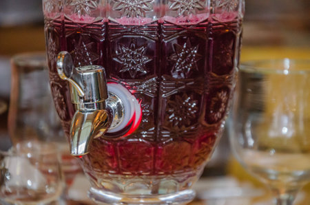 Drink in a glass carafe with a tap for pouring. High quality photoの写真素材