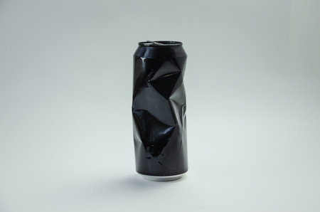 Crumpled aluminum black can on light background. High quality photoの写真素材