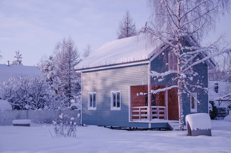 Small house in the snow, winter time. High quality photo