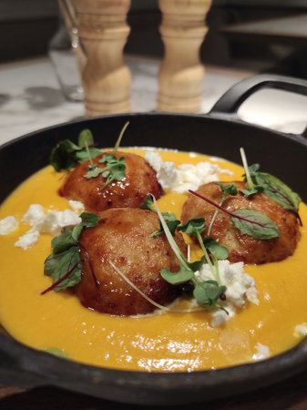 Cutlets in pumpkin sauce with feta cheese and herbs. High quality photo