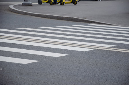 White stripes of the pedestrian crossing are drawn on the asphalt. High quality photoの写真素材