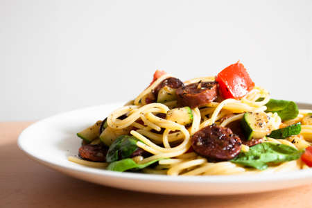 spaghetti with sausage and vegetableの写真素材