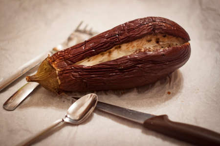baked aubergine with cutleryの写真素材