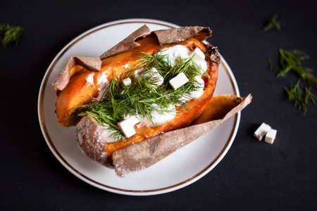baked sweet potato with cheese and dillの写真素材
