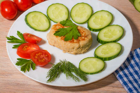 Light dinner of vegetables and steak on white plateの写真素材