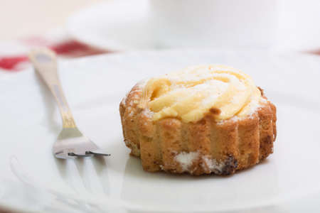 cake with cream filling on white plateの写真素材