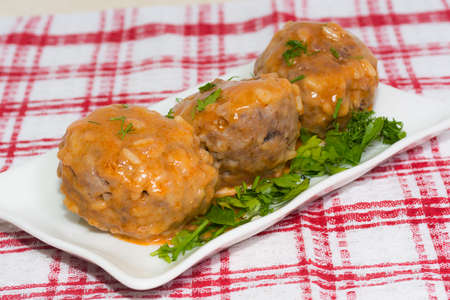 spicy meatballs in tomato sauce on white plate