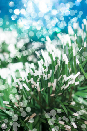 Natural background of Christmas tinsel with different blur the focus on the lensの写真素材