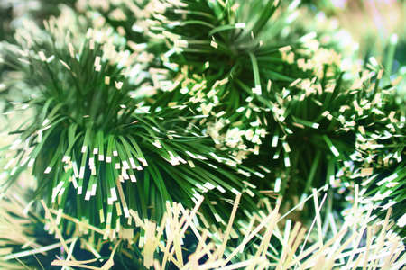 Natural background of Christmas tinsel with different blur the focus on the lensの写真素材