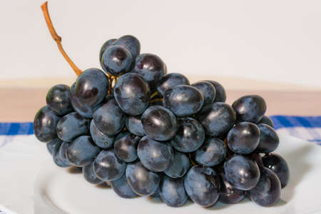 Red grape in white plate