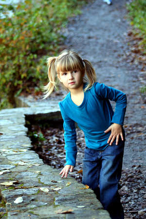 Little girl on rock ledge.の写真素材