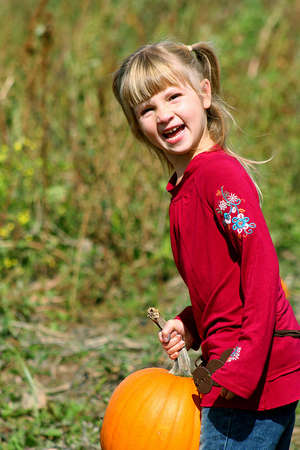 Little girl and pumpkinの写真素材