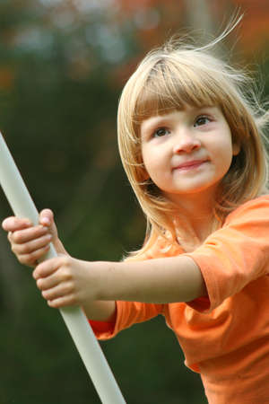 Little girl playin on swing.の写真素材