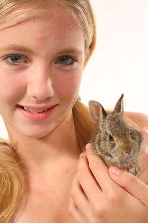Young blonde girl and wild  bunny.の写真素材