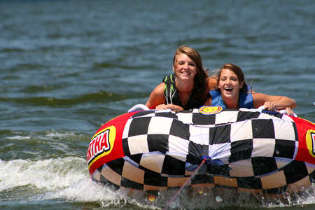 Two teenage girls having fun on lake.の写真素材