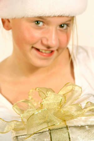 Close up of girl smiling holding christmas giftの写真素材