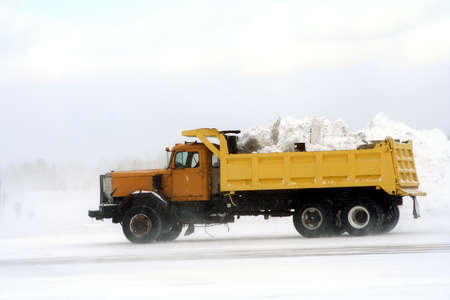 Dump truck hauling away snow at airportの写真素材