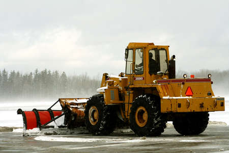Snow plow removing snow at airport
