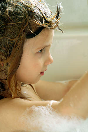 Little girl taking bubble bathの写真素材