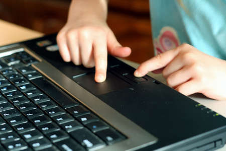 childs hands using laptop computerの写真素材