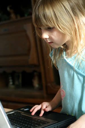 Little girl playing on laptop computerの写真素材