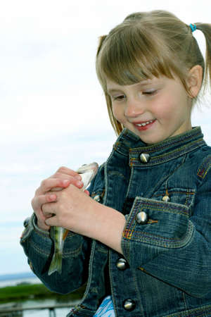 Girl with fish 3の写真素材