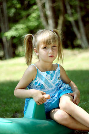 Expressive little girl outdoors on summer dayの写真素材
