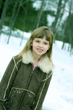 Close up of little girl outdoors with winter coatの写真素材