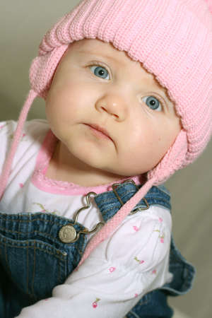 Baby girl wearing pink hatの写真素材