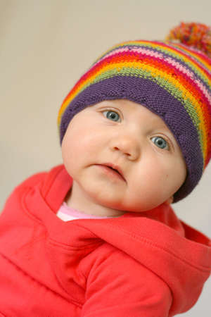 Sweet baby girl wearing colorful hatの写真素材