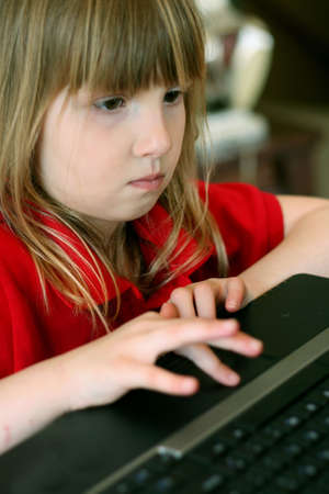 Close up of child on laptop computerの写真素材