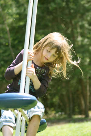 Little Girl Sitting on Teeter Totterの写真素材