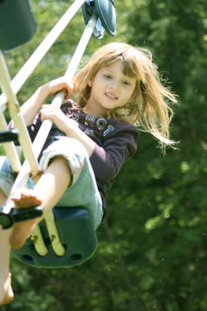 Little Girl in action on teeter totterの写真素材