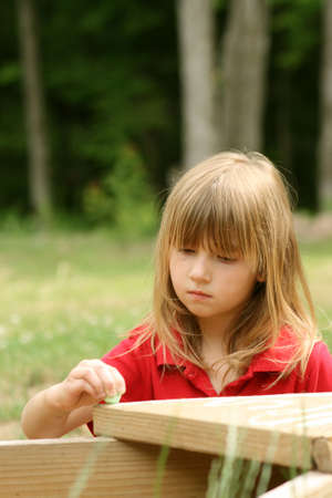 Little girl alone outdoors on summer dayの写真素材