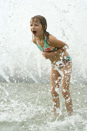 Little girl playing in fountain 2の写真素材