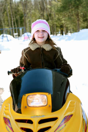 Little girl on snowmobileの写真素材