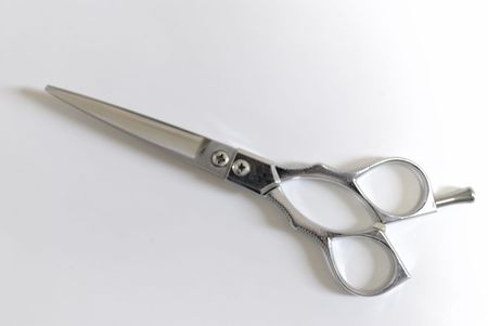 Cutting scissors of argent that turn on diagonal the leftの写真素材