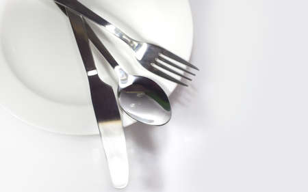 Fork spoon and knife isolated on white の写真素材