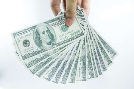 hand with pack of one hundred dollarsの写真素材