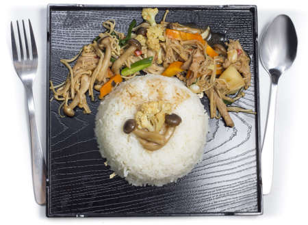 Mushrooms stir fry with rice on black plateの写真素材