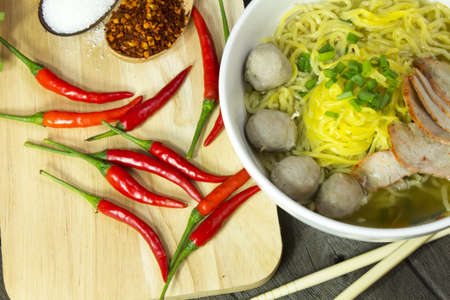 Yellow noodles delicious on wood floorsの写真素材