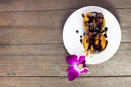 Coffee and sweets to tasty on a wooden floorの写真素材