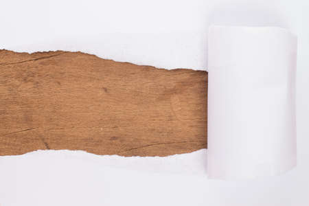 ripped paper on woodの写真素材